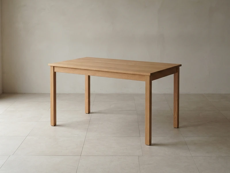 Single plain wooden table on an open tiled floor under soft daylight